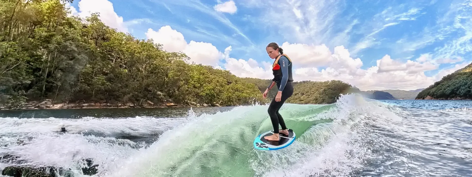 Photo of female wake surfing on a Phase Five Scamp wake surf board